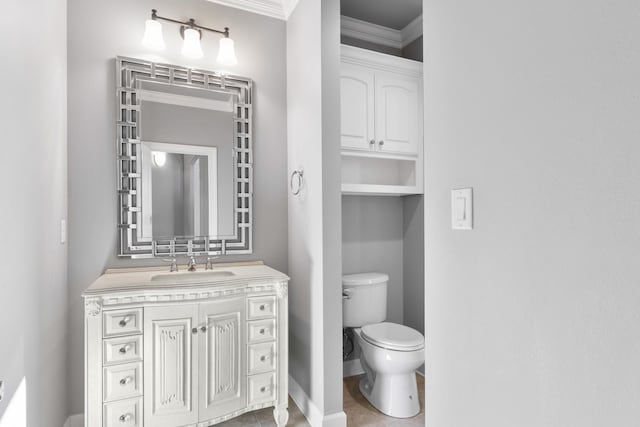 bathroom featuring baseboards, toilet, ornamental molding, tile patterned flooring, and vanity