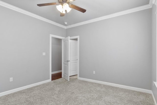 unfurnished bedroom featuring ornamental molding, carpet flooring, and baseboards