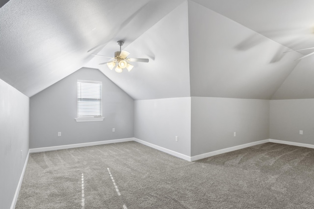 additional living space with carpet floors, vaulted ceiling, and baseboards