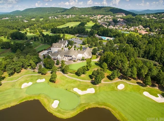 drone / aerial view with golf course view and a water and mountain view