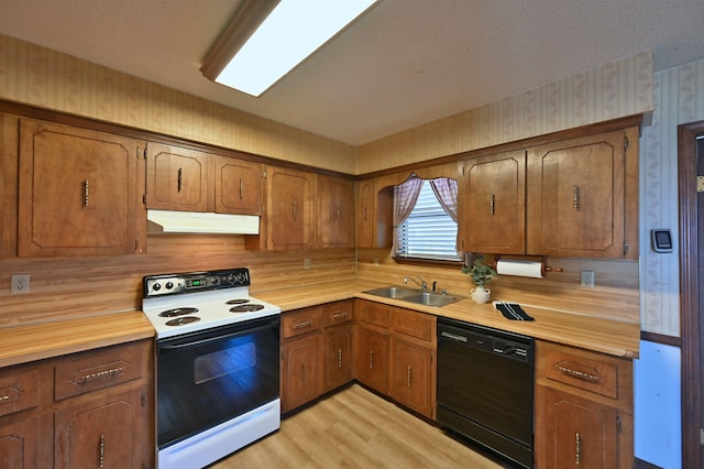 kitchen featuring light countertops, electric range, a sink, dishwasher, and wallpapered walls