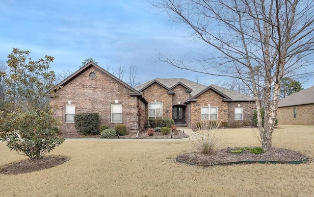 ranch-style house with brick siding and a front lawn