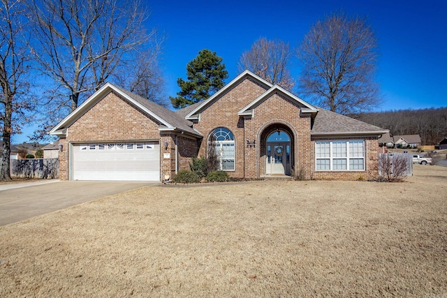 view of front of home featuring concrete driveway, brick siding, french doors, and an attached garage