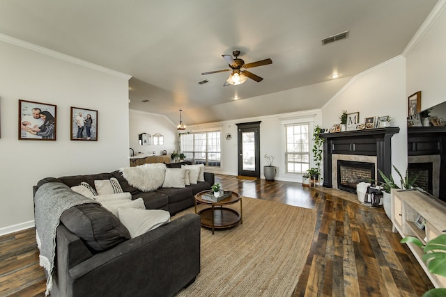 living area with ornamental molding, a fireplace, and visible vents