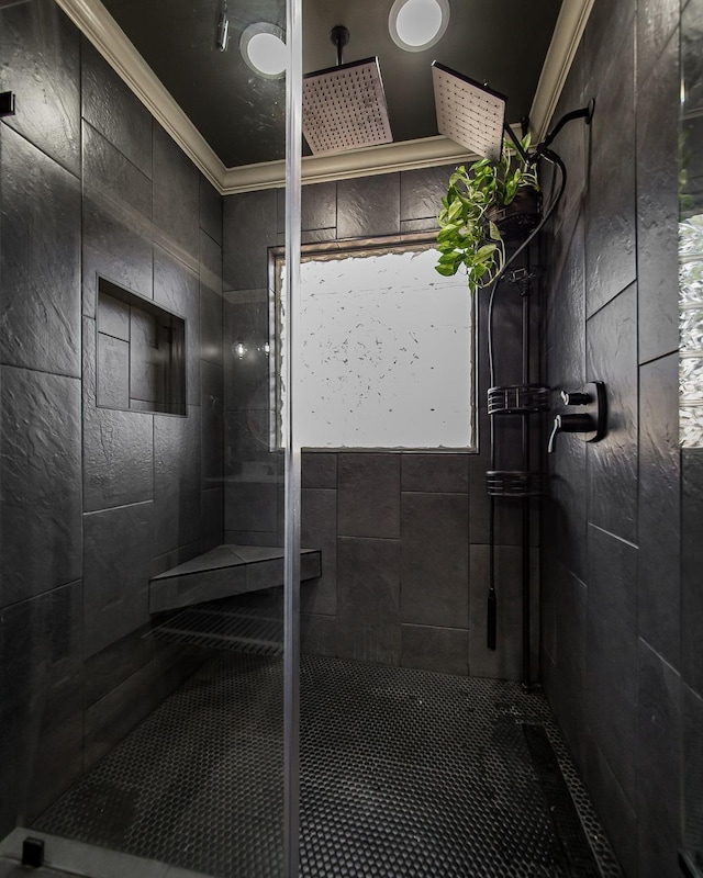 bathroom featuring ornamental molding and tiled shower