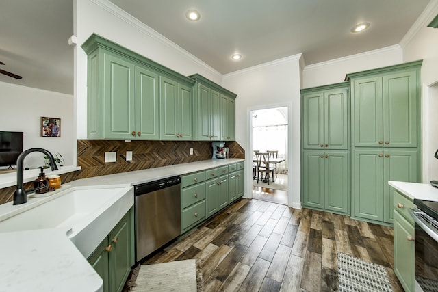 kitchen with a sink, stainless steel appliances, light countertops, and green cabinetry