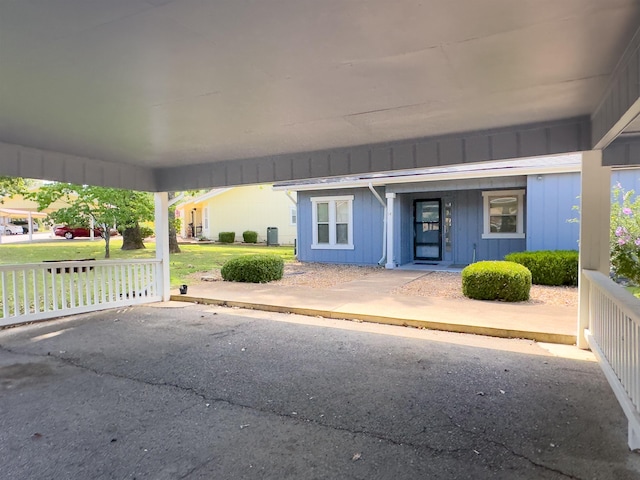 doorway to property with a lawn