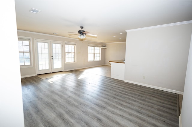 unfurnished room with ornamental molding, visible vents, baseboards, and wood finished floors