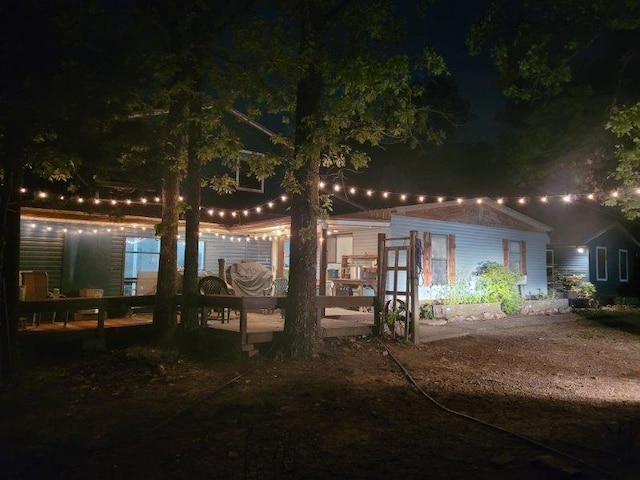 view of back of house at night