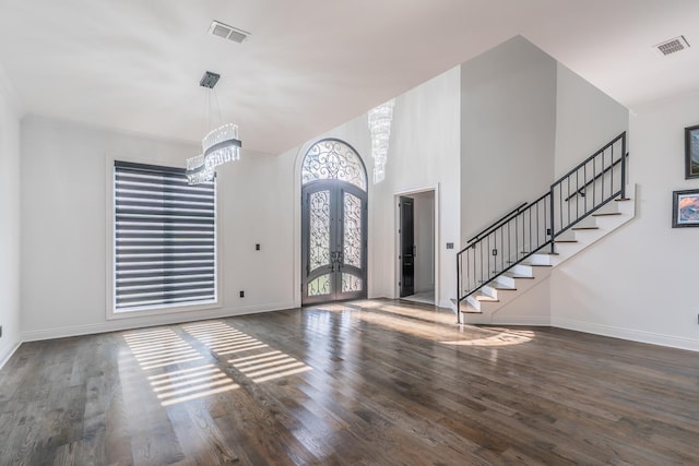 entryway with stairway, visible vents, dark wood finished floors, and french doors