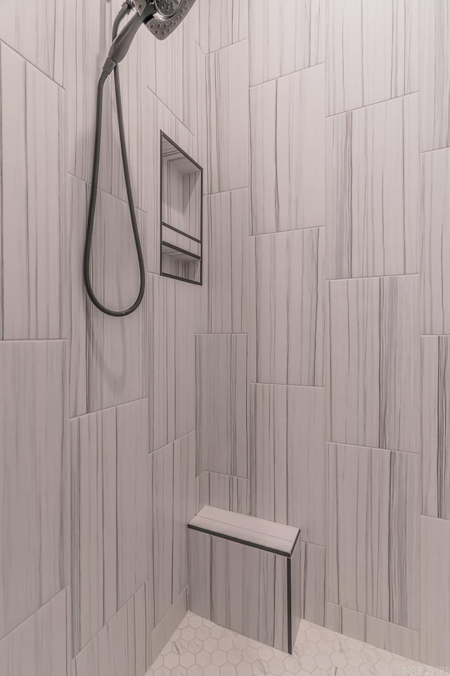 full bath featuring a tile shower