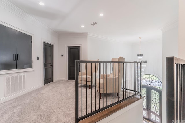 hall with light carpet, visible vents, and crown molding