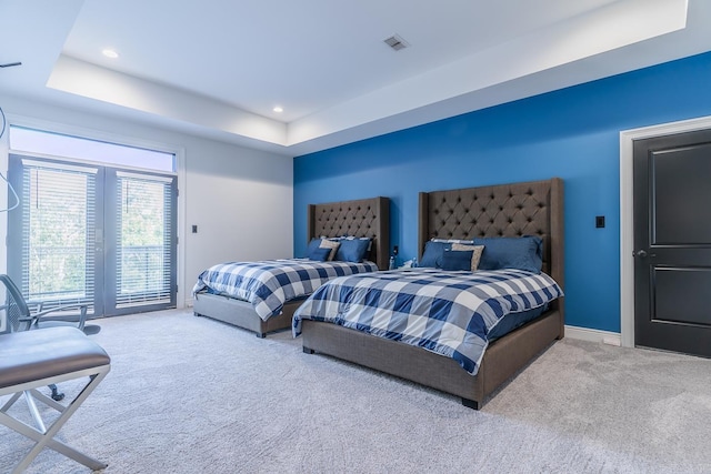 carpeted bedroom with a tray ceiling, recessed lighting, visible vents, access to outside, and baseboards