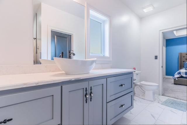 bathroom featuring marble finish floor, vanity, and toilet