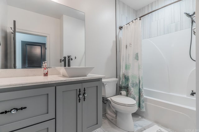 bathroom featuring shower / tub combo, marble finish floor, toilet, and vanity