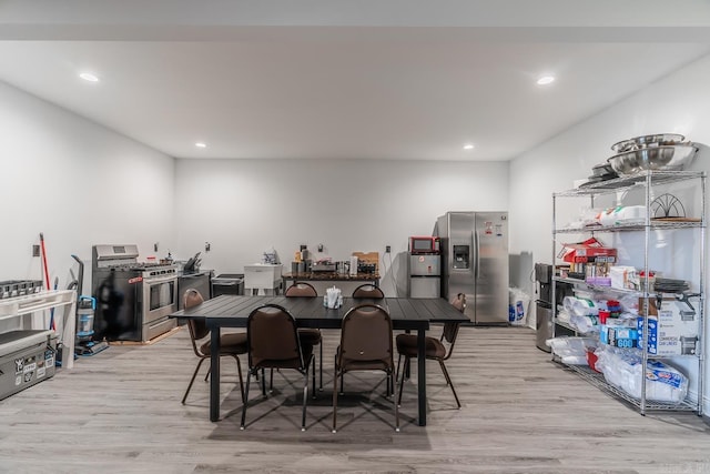 dining space with light wood-style flooring and recessed lighting