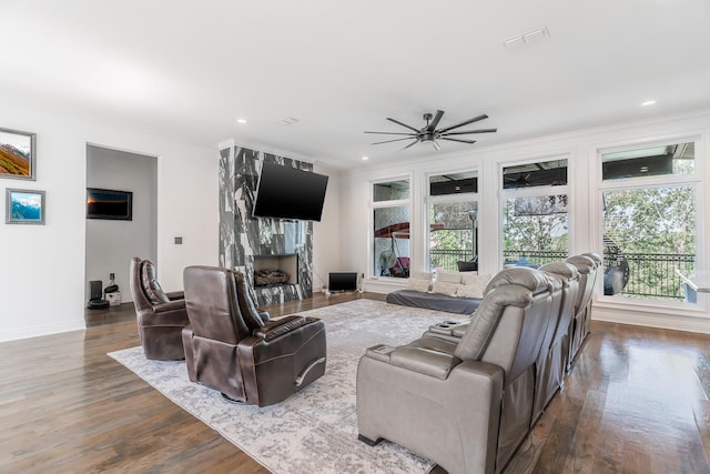 living area with baseboards, dark wood finished floors, a high end fireplace, crown molding, and recessed lighting