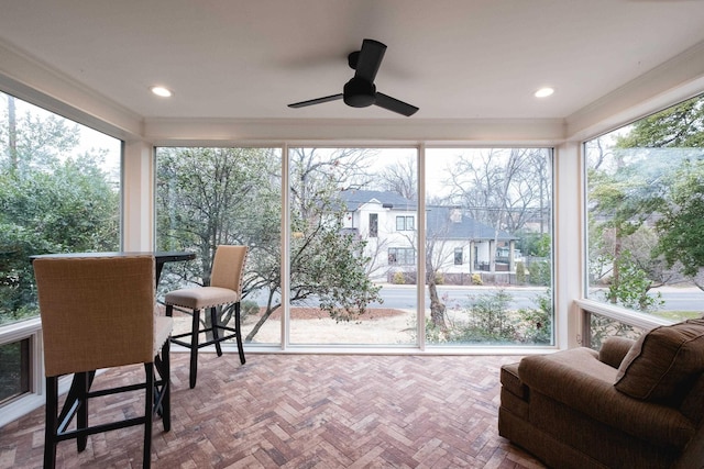 sunroom with a ceiling fan