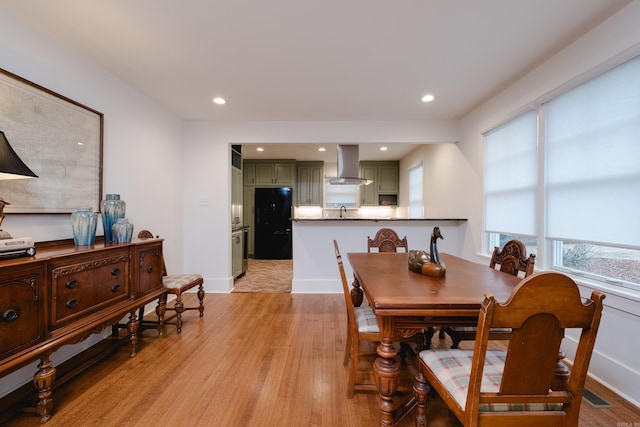 dining space featuring light wood-type flooring, visible vents, baseboards, and recessed lighting