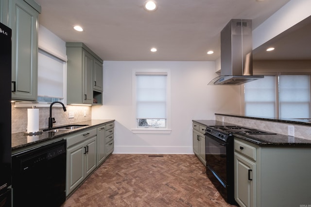 kitchen with island range hood, a sink, backsplash, dark stone counters, and black appliances