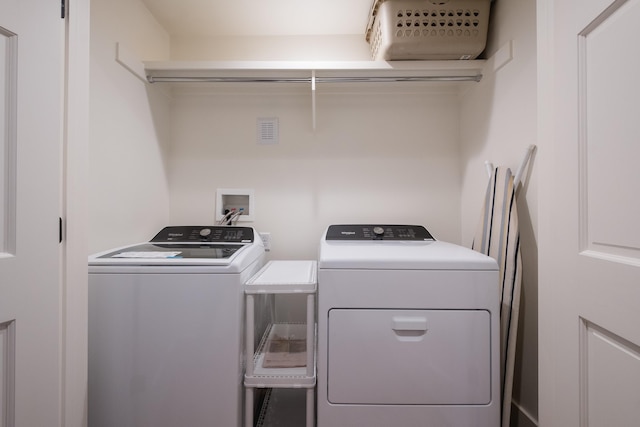 laundry area with laundry area and washer and clothes dryer