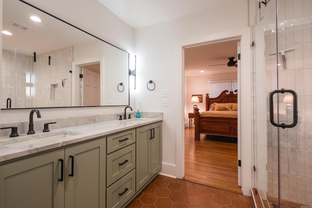 ensuite bathroom featuring ceiling fan, visible vents, a sink, and ensuite bathroom