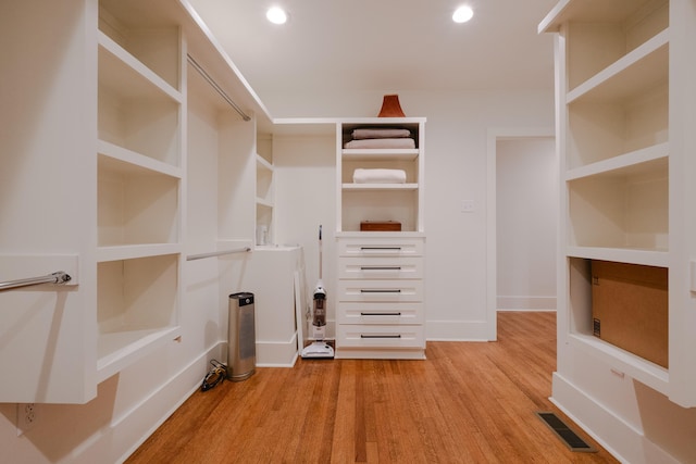 walk in closet featuring visible vents and wood finished floors