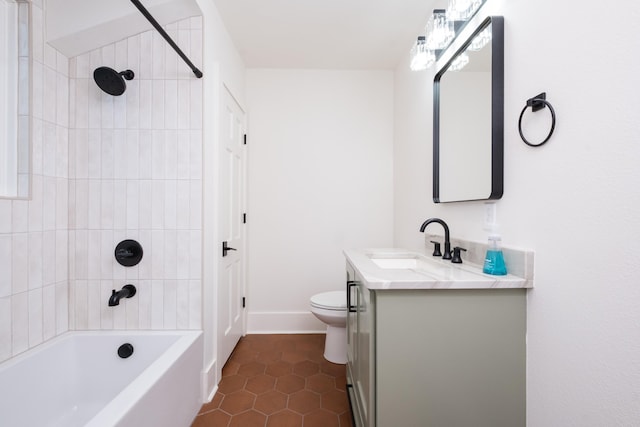 bathroom with baseboards, toilet, tile patterned floors, vanity, and shower / bathing tub combination