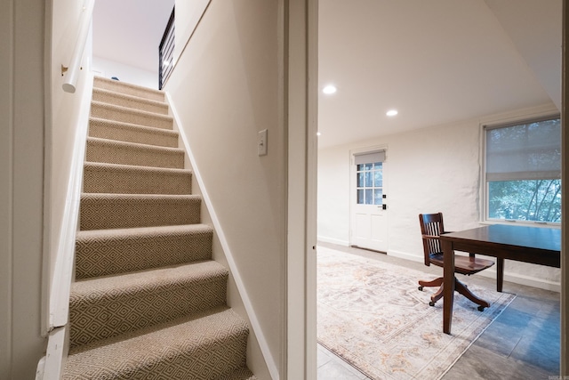 stairs with baseboards and recessed lighting