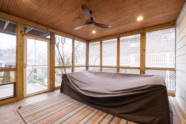 sunroom featuring wooden ceiling and a ceiling fan