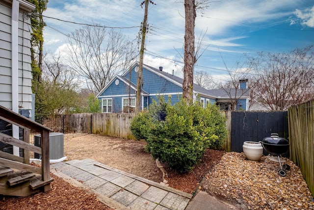 view of yard featuring a fenced backyard and a gate