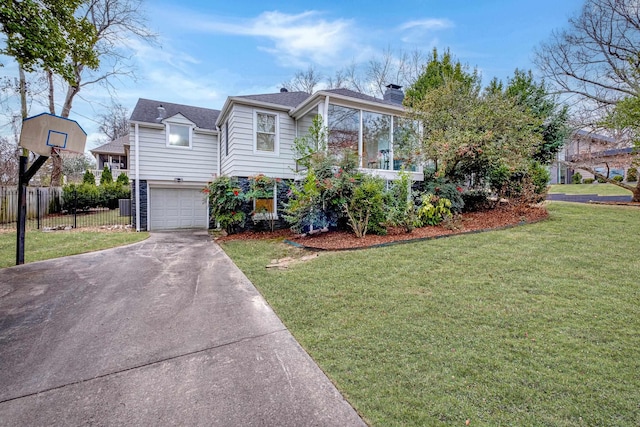 view of front of property featuring a chimney, an attached garage, fence, driveway, and a front lawn