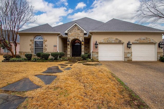 view of front facade featuring an attached garage, stone siding, driveway, and a shingled roof