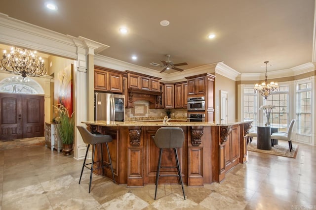 kitchen featuring decorative light fixtures, a breakfast bar area, smart refrigerator, brown cabinetry, and a large island with sink