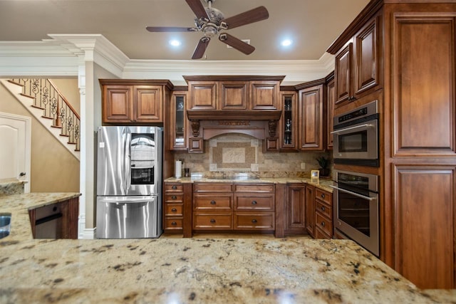 kitchen with stainless steel appliances, glass insert cabinets, decorative backsplash, and light stone countertops