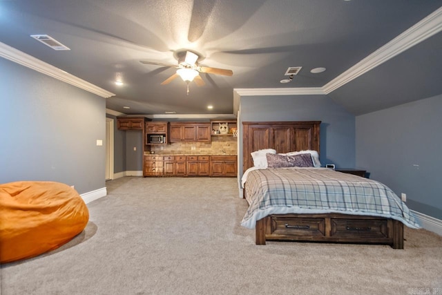 bedroom featuring lofted ceiling, light colored carpet, visible vents, baseboards, and crown molding