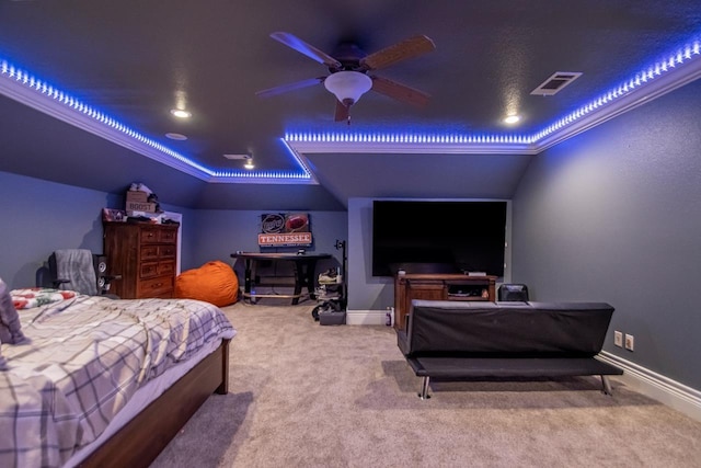 bedroom with carpet, a tray ceiling, visible vents, and baseboards