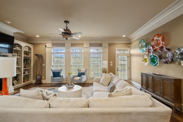 living room featuring ornamental molding, dark wood-style flooring, and baseboards