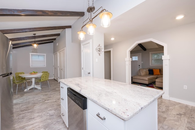 kitchen with arched walkways, white cabinets, hanging light fixtures, appliances with stainless steel finishes, and a center island