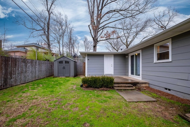 view of yard with an outbuilding, a shed, and fence