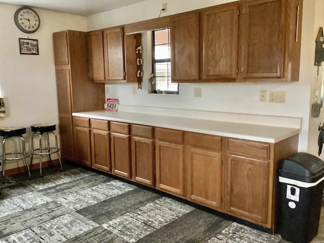 kitchen with light countertops and brown cabinets