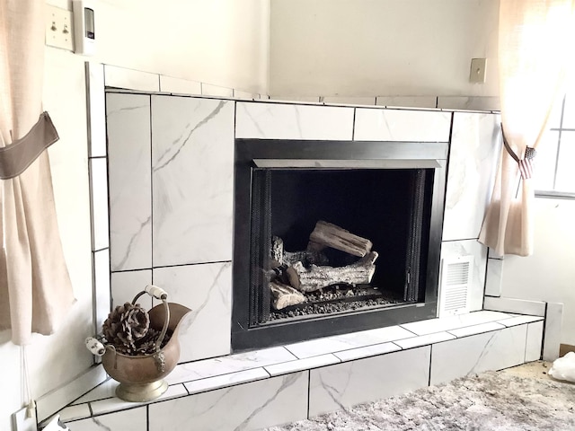 room details featuring a fireplace and visible vents