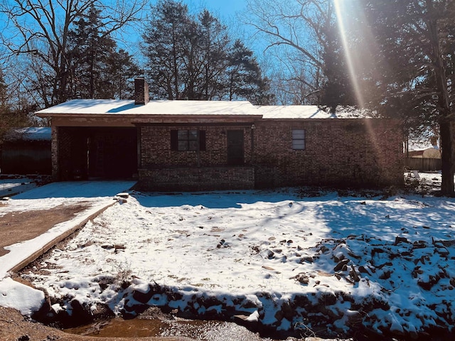 exterior space featuring a chimney and an attached garage