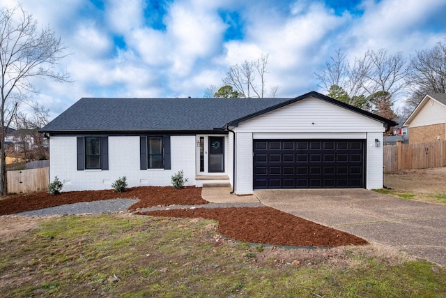 ranch-style home with brick siding, roof with shingles, concrete driveway, an attached garage, and crawl space