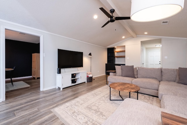 living area featuring baseboards, visible vents, a ceiling fan, vaulted ceiling with beams, and light wood-style floors