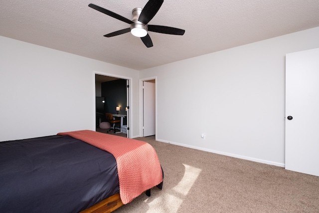 bedroom featuring carpet floors, a textured ceiling, baseboards, and a ceiling fan