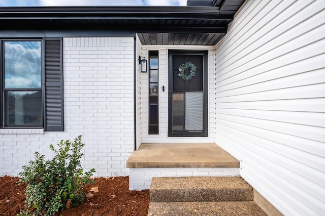 property entrance with brick siding