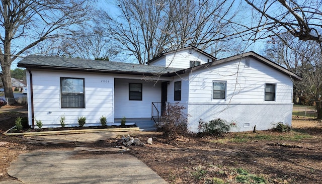 view of front of property featuring crawl space and brick siding