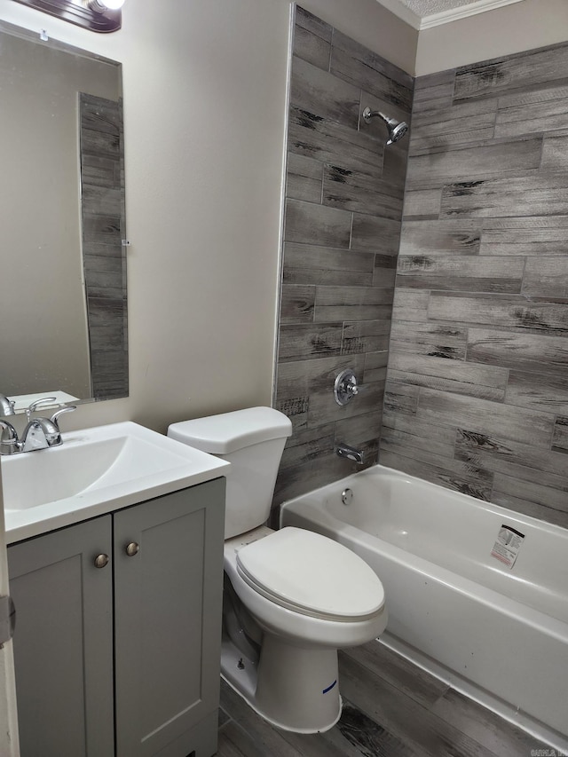 bathroom featuring wood finished floors, bathing tub / shower combination, toilet, and vanity