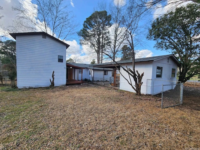 back of house featuring a yard and fence